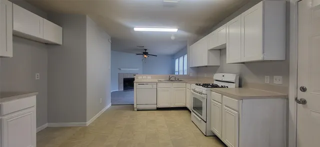 a kitchen with a sink stove and cabinets