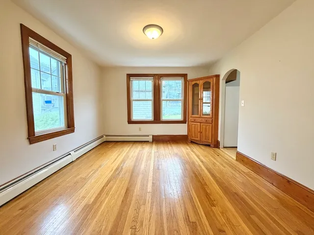 wooden floor in an empty room with a window