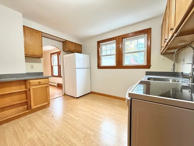 a kitchen with a refrigerator and a sink