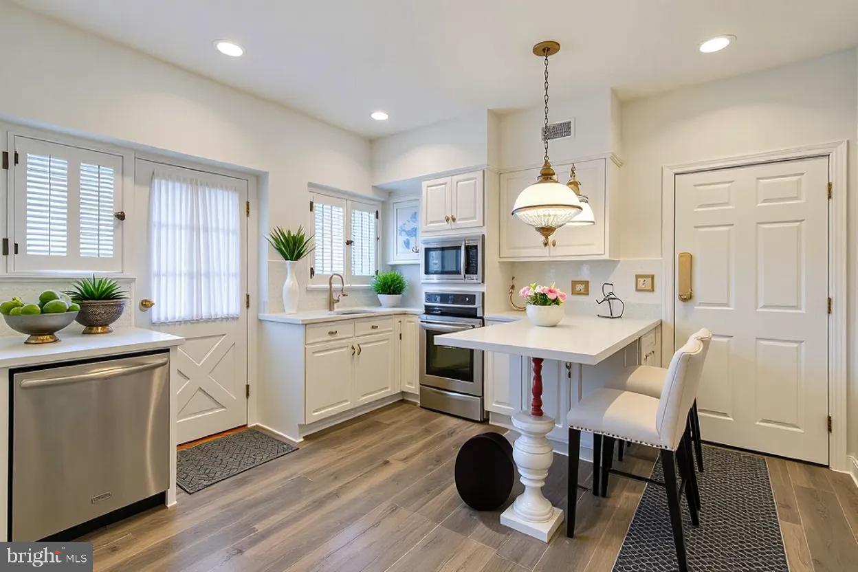 302 Tunbridge Road Baltimore, MD 21212 - Photo 20 of 77 a kitchen with a sink cabinets and wooden floor