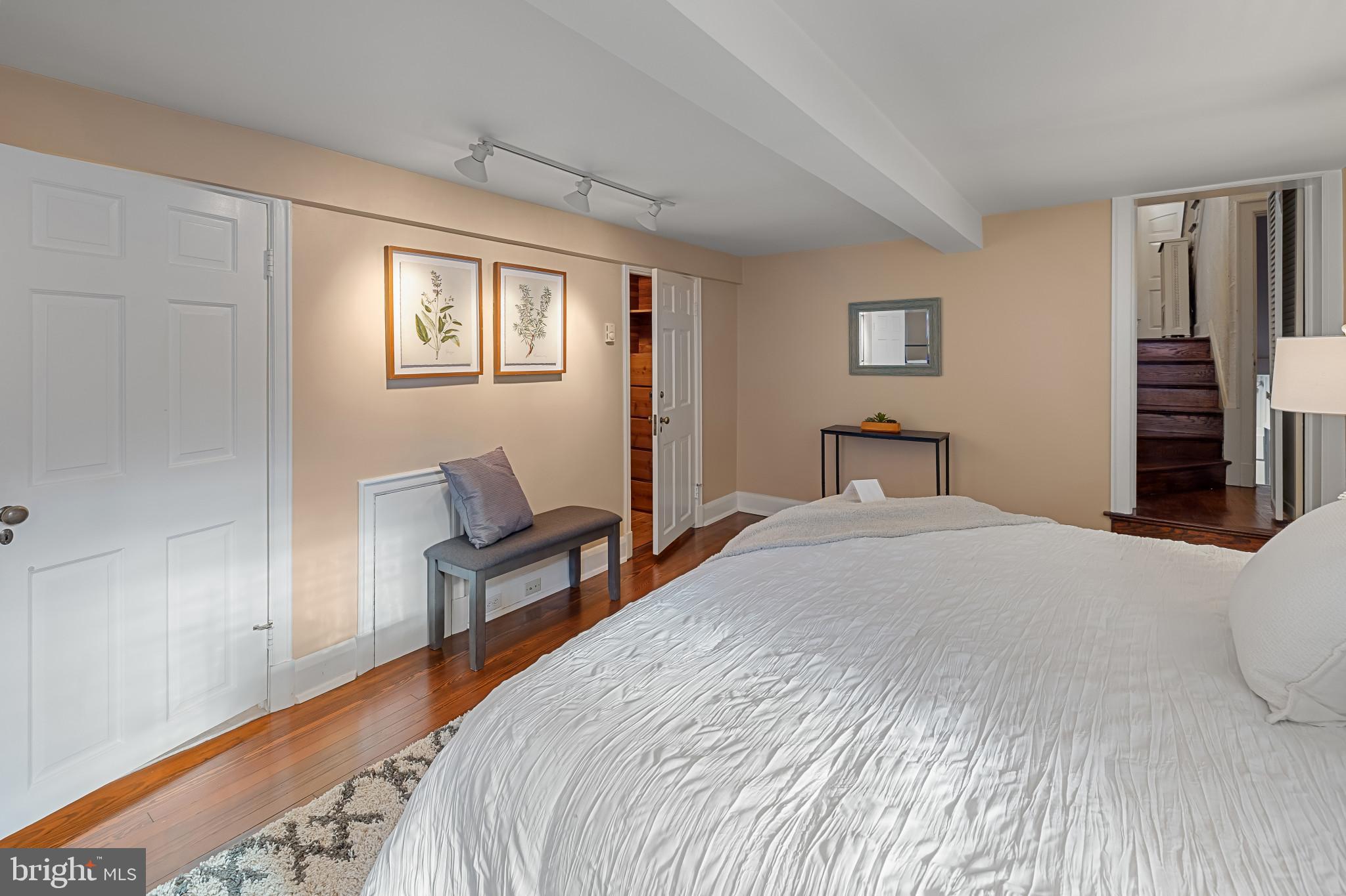 302 Tunbridge Road Baltimore, MD 21212 - Photo 21 of 77 a bedroom with a bed and a chair