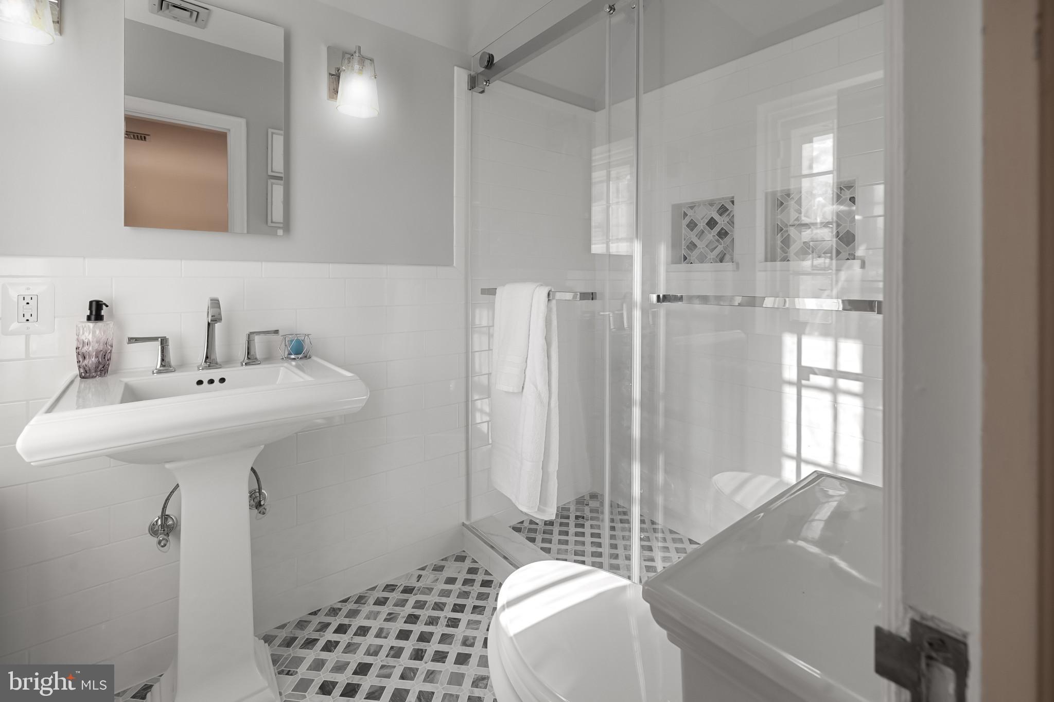 302 Tunbridge Road Baltimore, MD 21212 - Photo 30 of 77 a bathroom with a sink a mirror and a shower