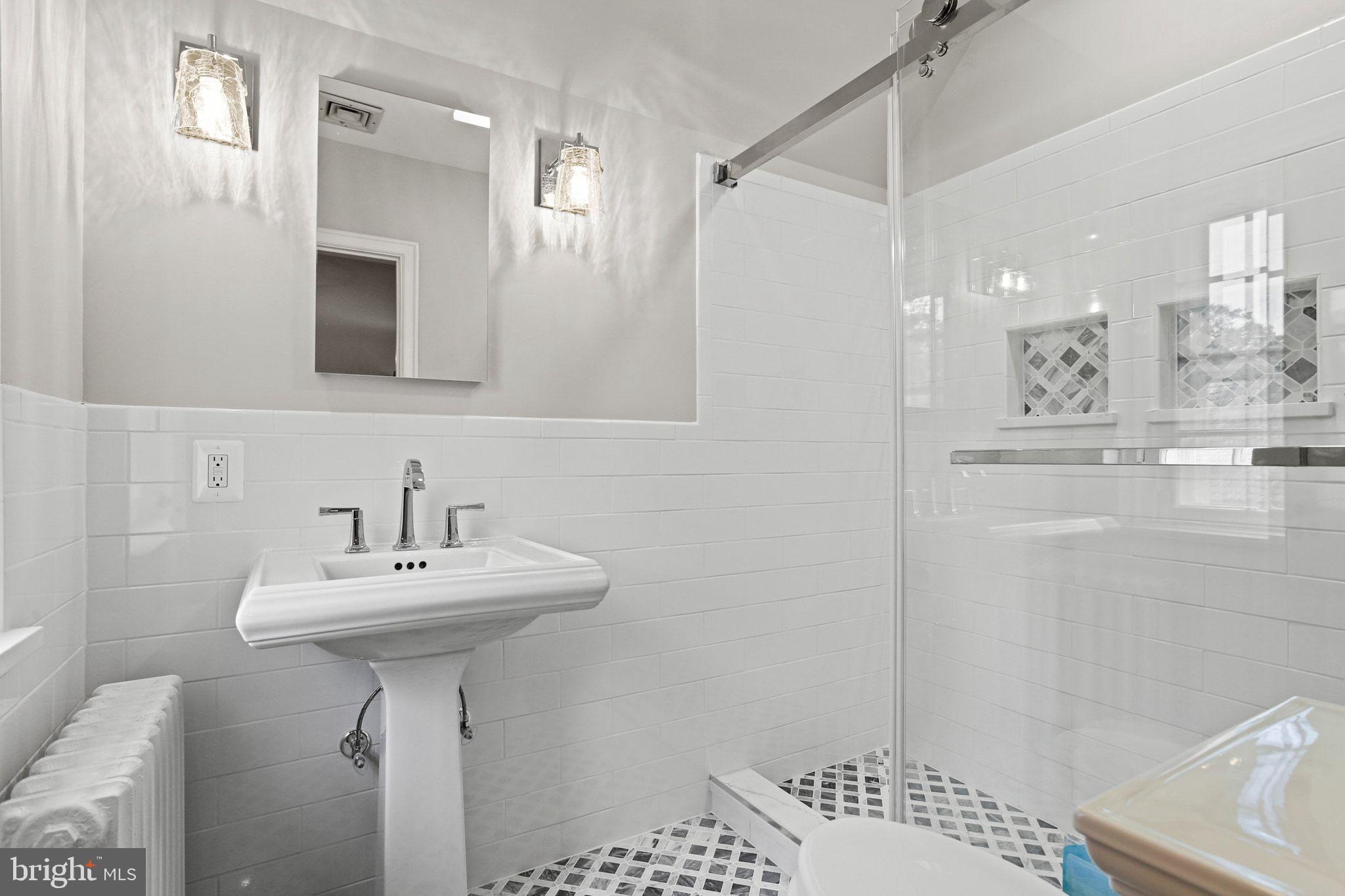 302 Tunbridge Road Baltimore, MD 21212 - Photo 31 of 77 a bathroom with a sink a mirror and shower