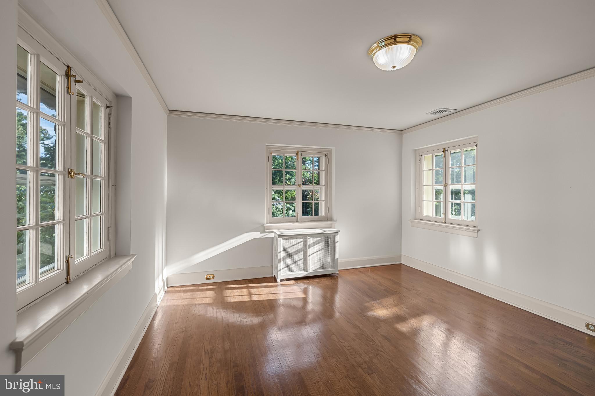 302 Tunbridge Road Baltimore, MD 21212 - Photo 32 of 77 a view of an empty room with wooden floor and a window