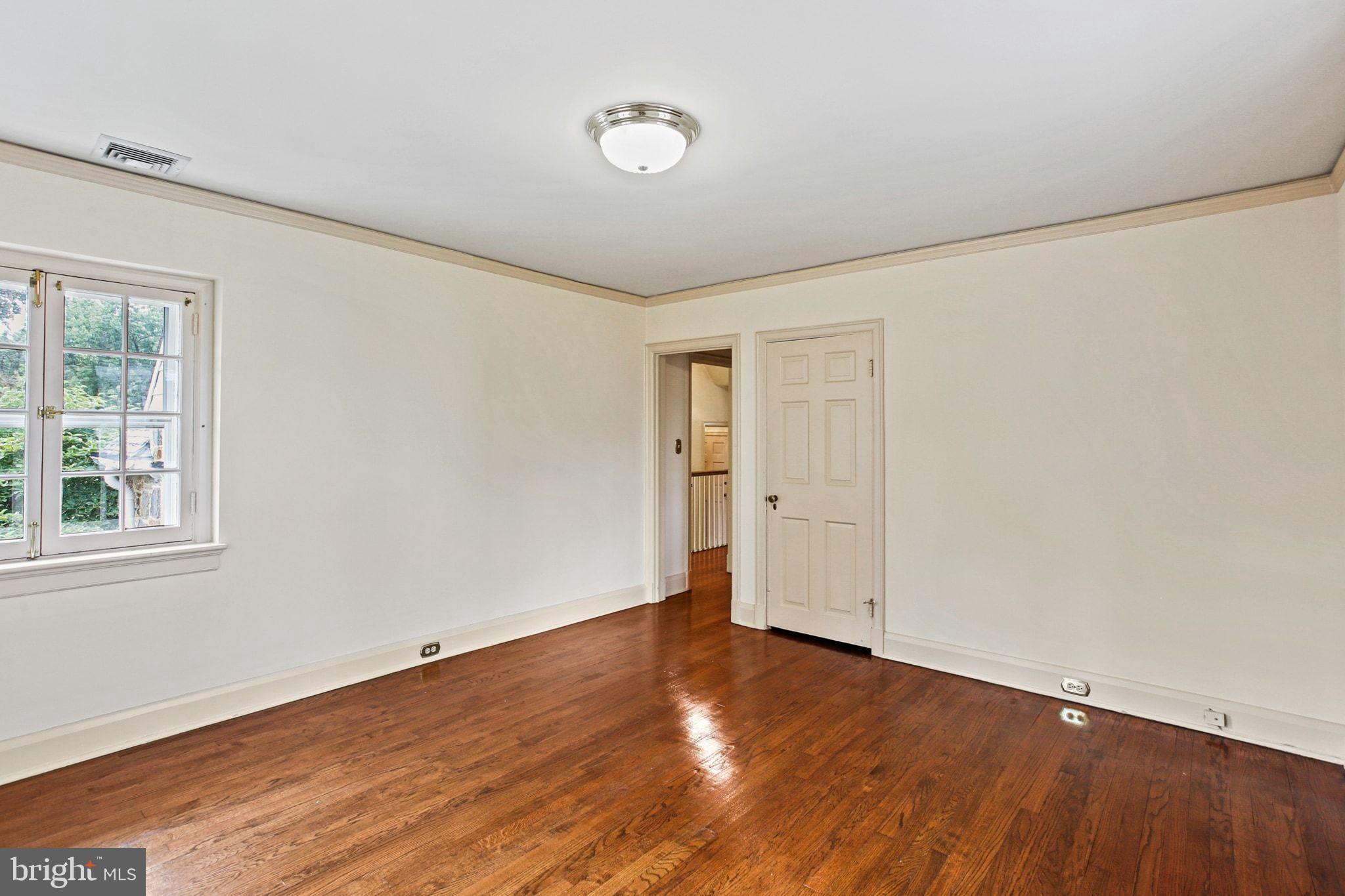 302 Tunbridge Road Baltimore, MD 21212 - Photo 35 of 77 an empty room with wooden floor and windows