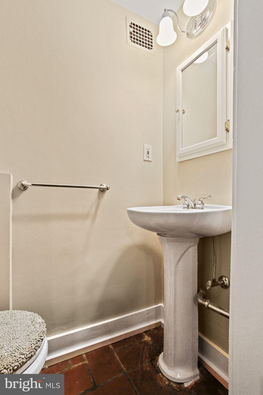 302 Tunbridge Road Baltimore, MD 21212 - Photo 49 of 77 a bathroom with a sink and a mirror