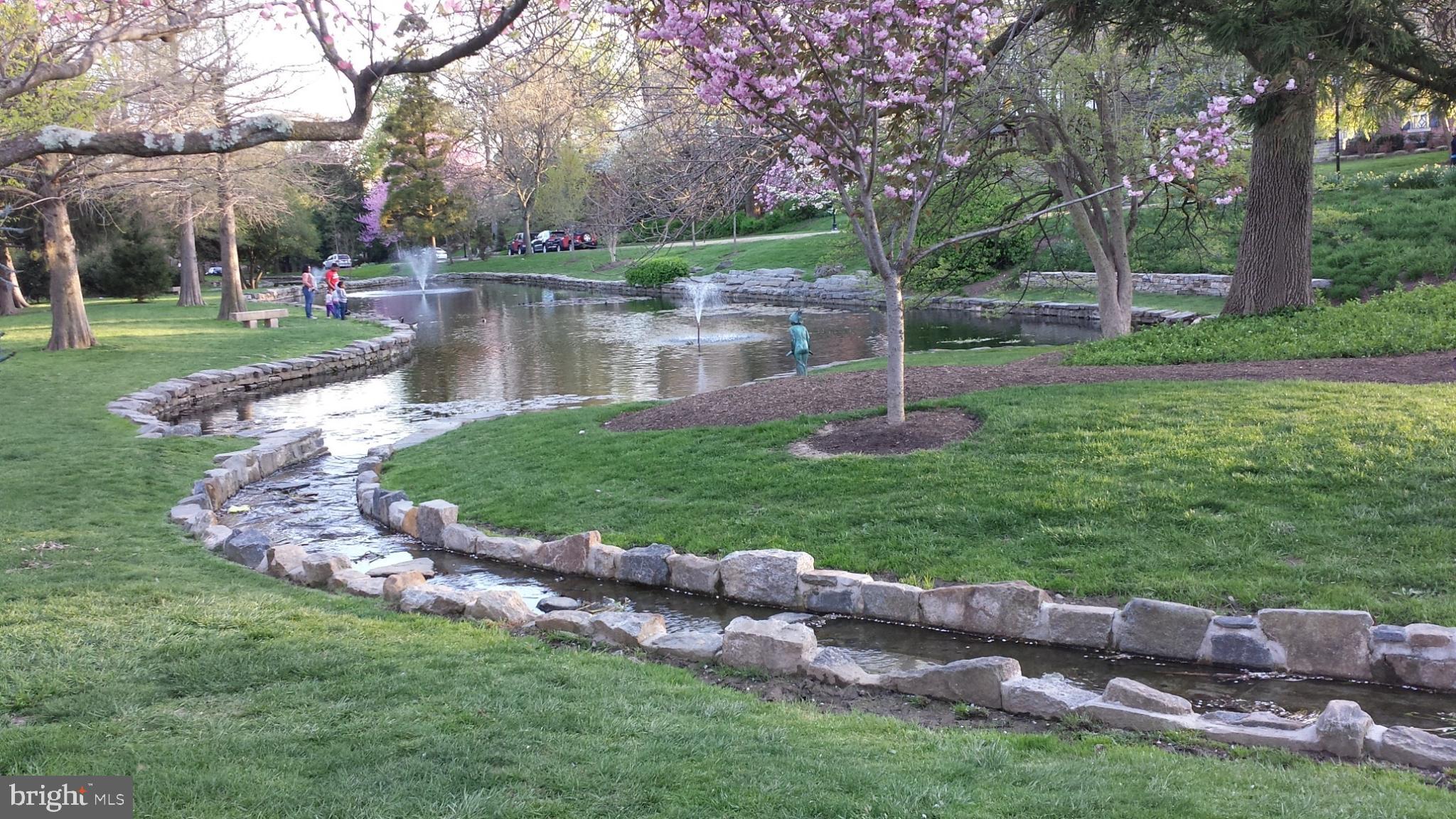 302 Tunbridge Road Baltimore, MD 21212 - Photo 66 of 77 Serene park scene with blooming trees.