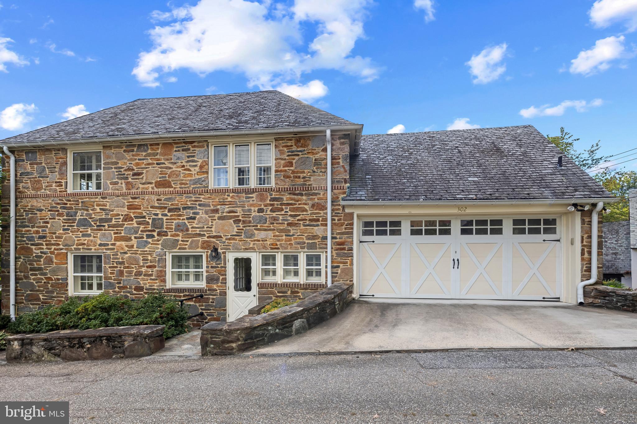 302 Tunbridge Road Baltimore, MD 21212 - Photo 70 of 77 a front view of a house with a yard and garage