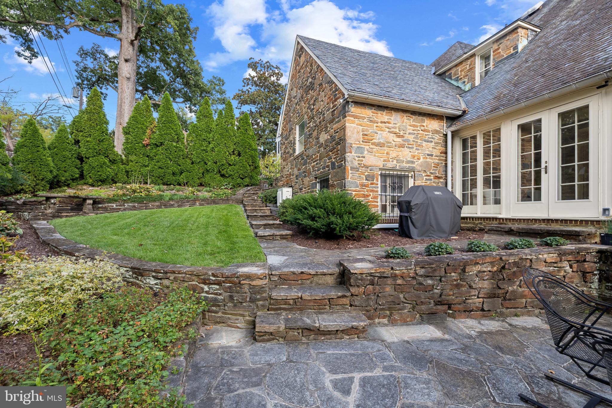 302 Tunbridge Road Baltimore, MD 21212 - Photo 72 of 77 Charming stone patio with lush greenery.
