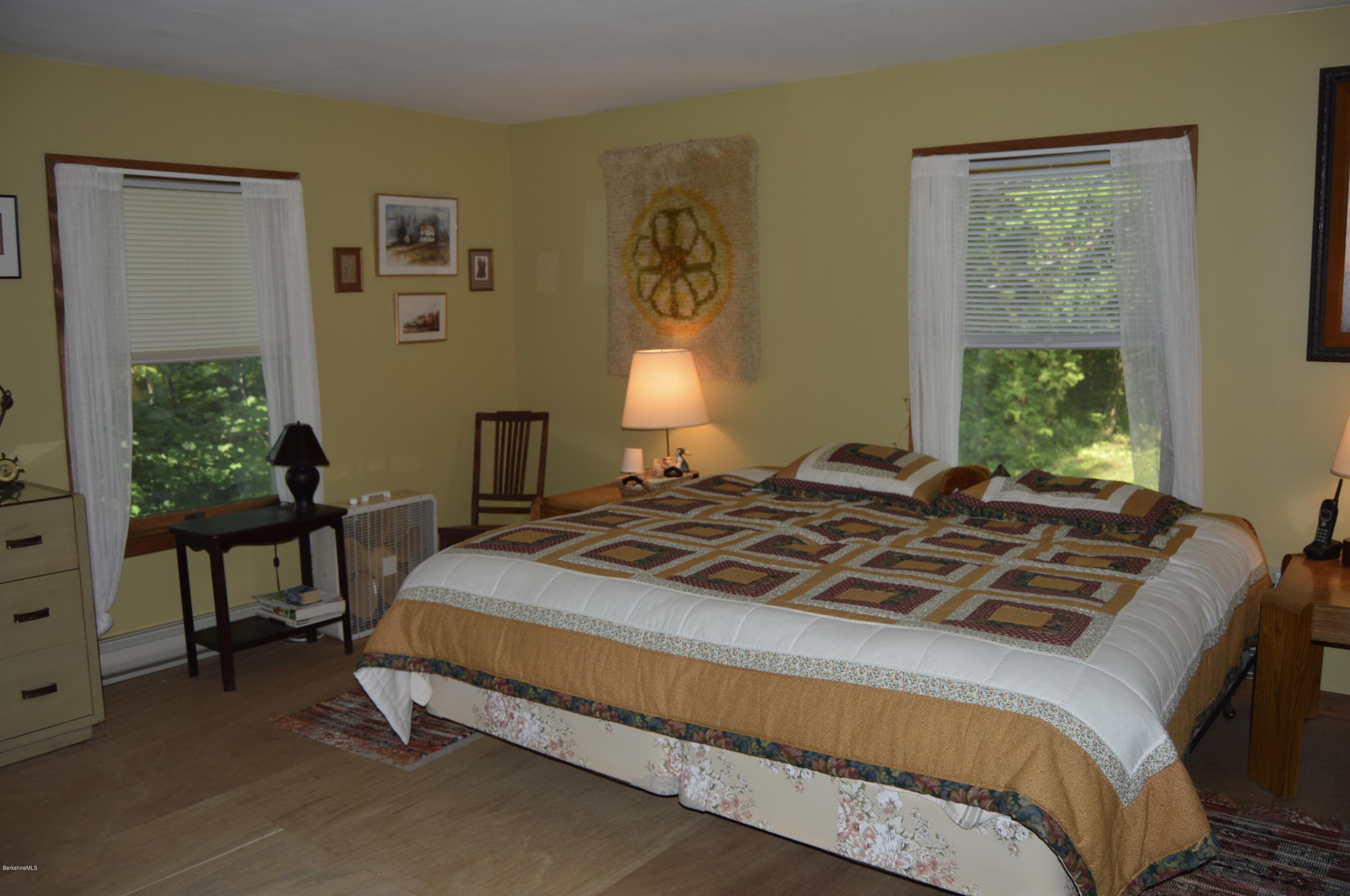 2965 Hancock Road Hancock, MA 01267 - Photo 22 of 33 a bedroom with a bed table chair and a window