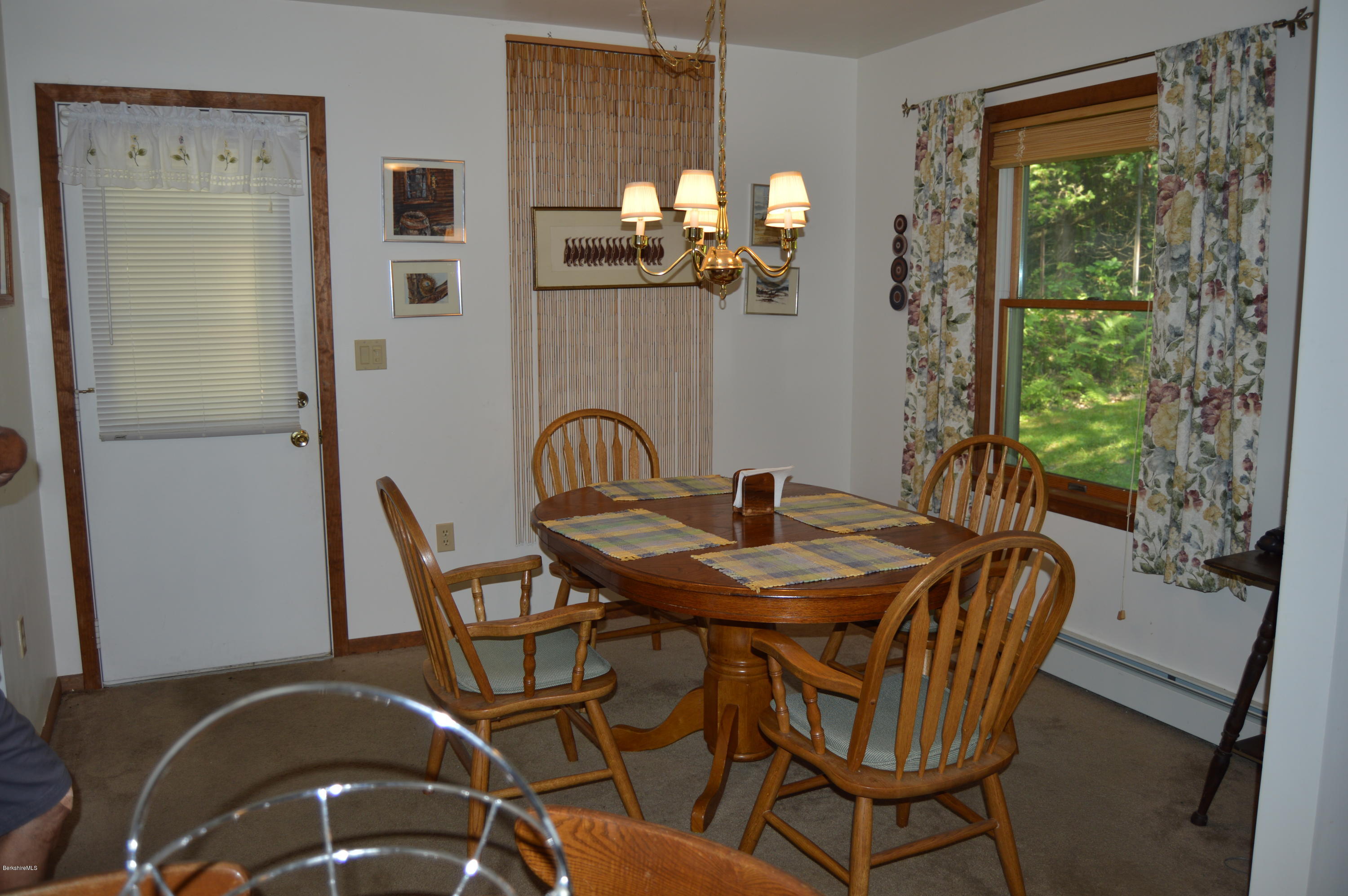 2965 Hancock Road Hancock, MA 01267 - Photo 10 of 33 a view of a dining room with furniture a chandelier and large windows