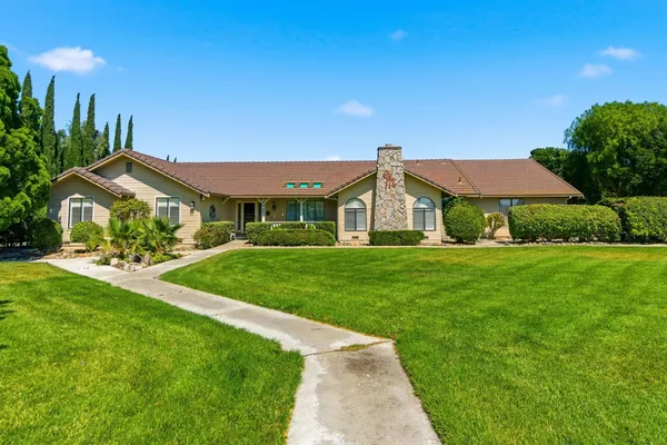 a front view of house with yard and green space