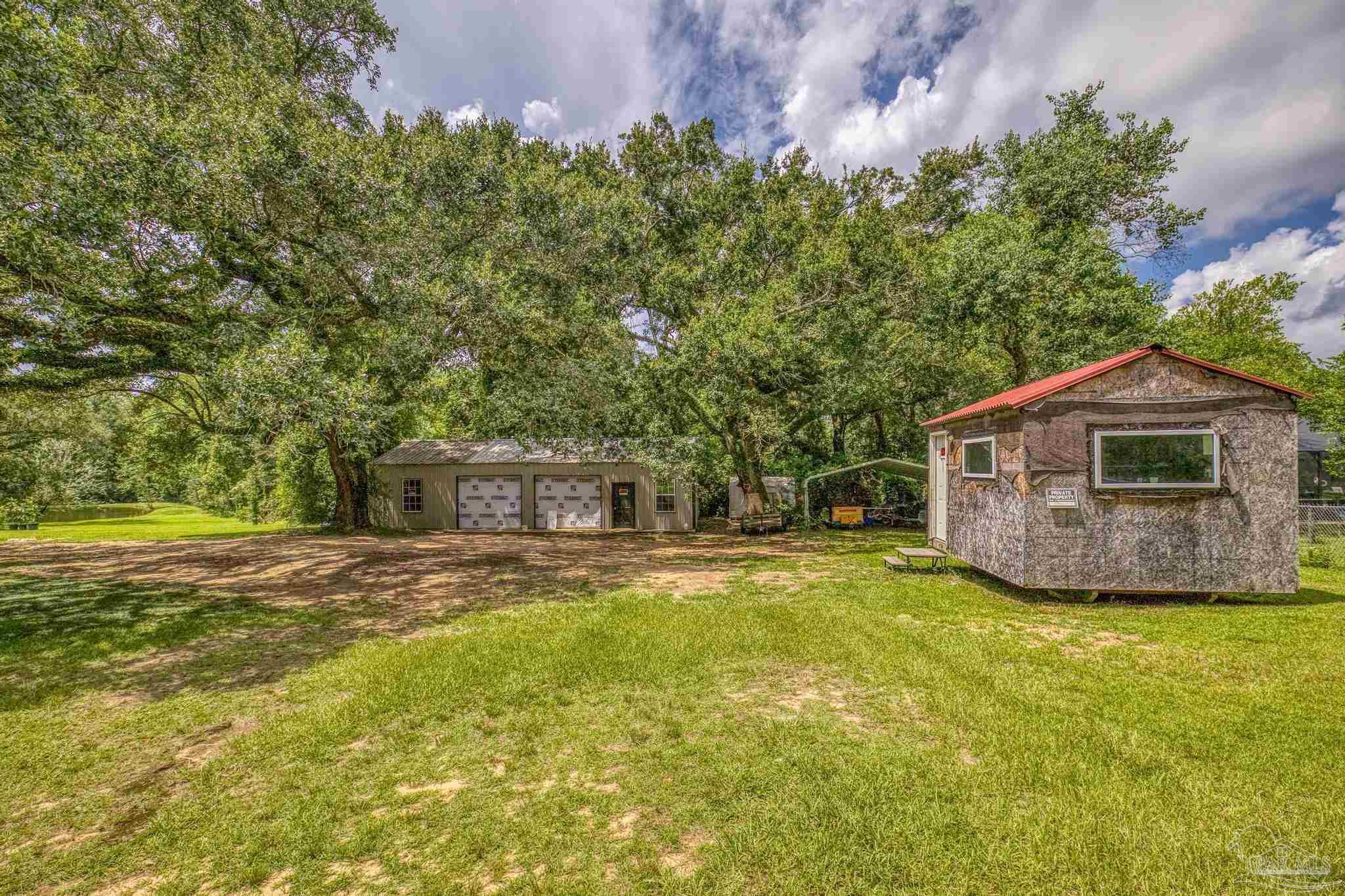 2345 Pompano Street Cantonment, FL 32533 - Photo 4 of 48 a view of a house with a yard
