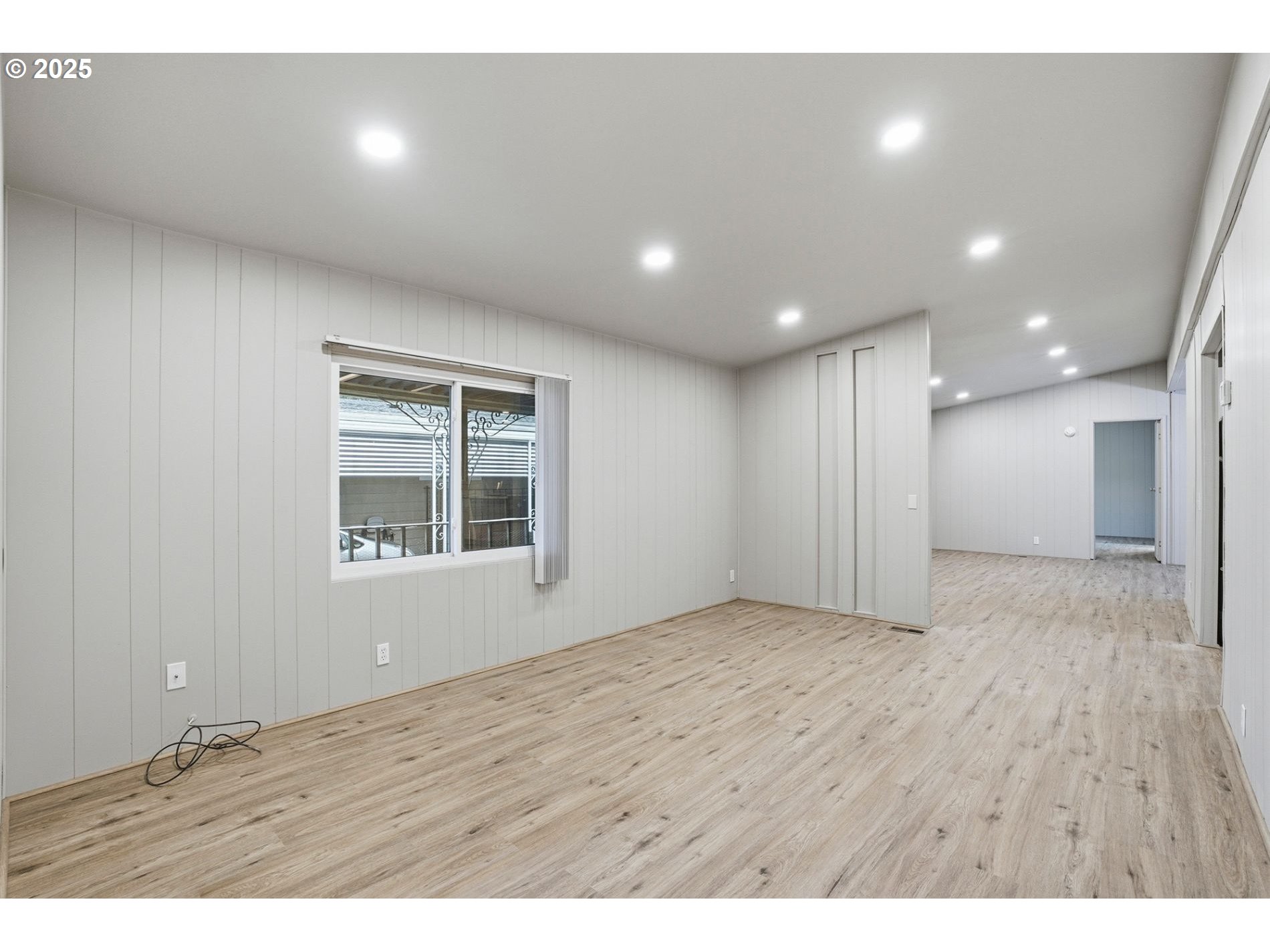 21100 Northeast Sandy Boulevard, Unit 59 Fairview, OR 97024 - Photo 2 of 16 a view of an empty room with wooden floor and a window