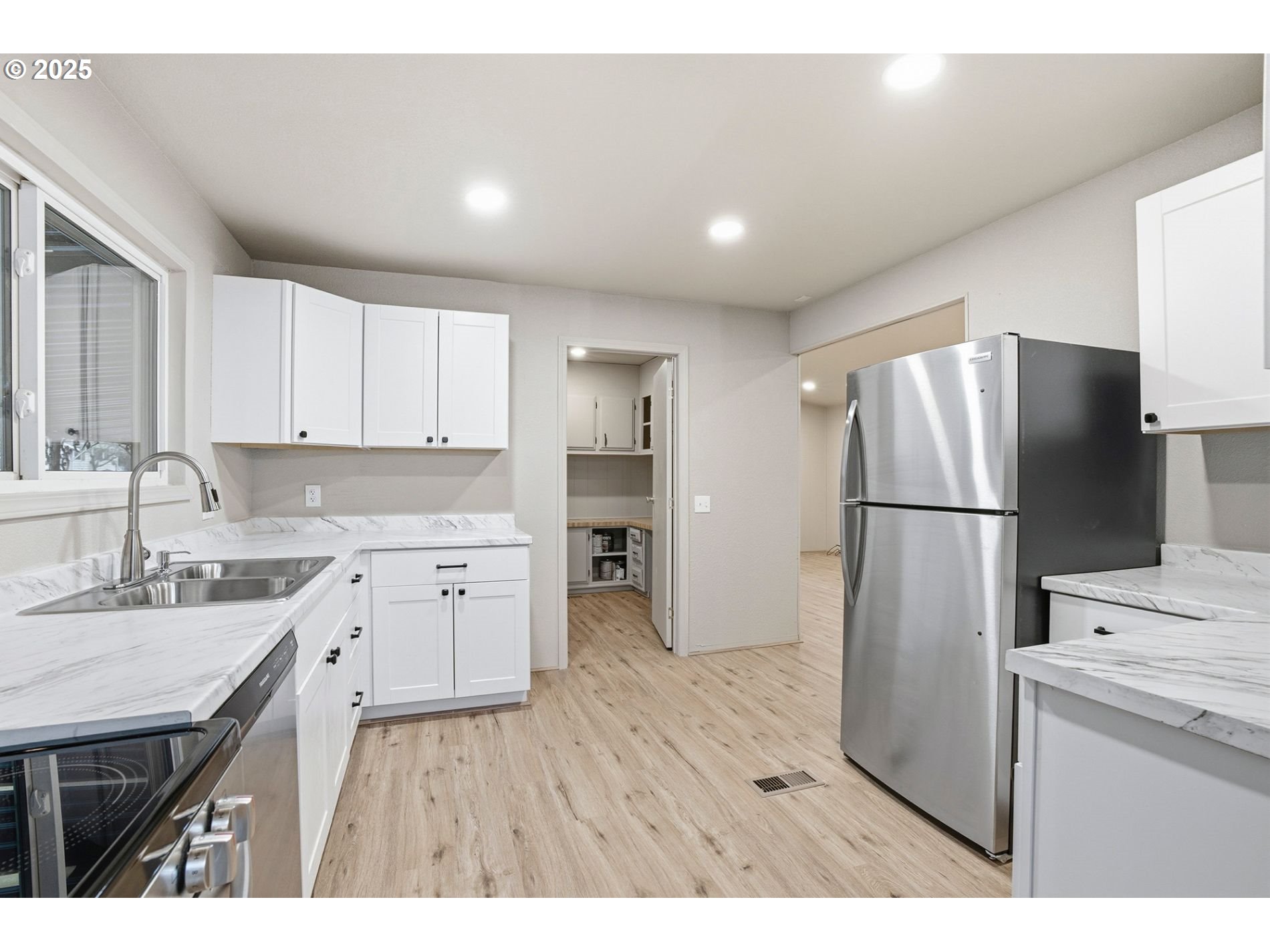 21100 Northeast Sandy Boulevard, Unit 59 Fairview, OR 97024 - Photo 10 of 16 a kitchen with a refrigerator sink and cabinets