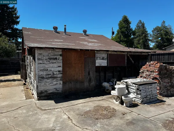 a view of a backyard with chairs and floor to ceiling window