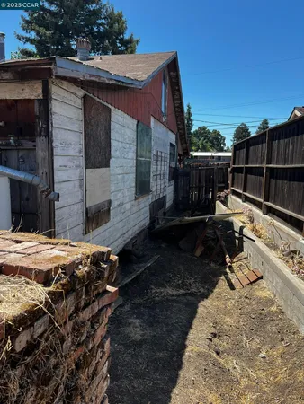 a backyard of a house with barbeque oven and outdoor seating