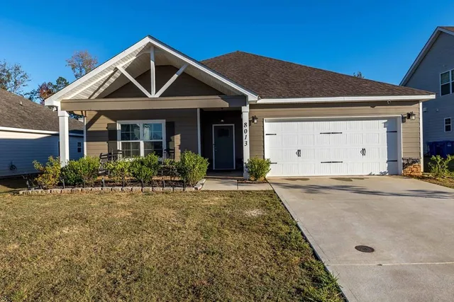a front view of a house with garden