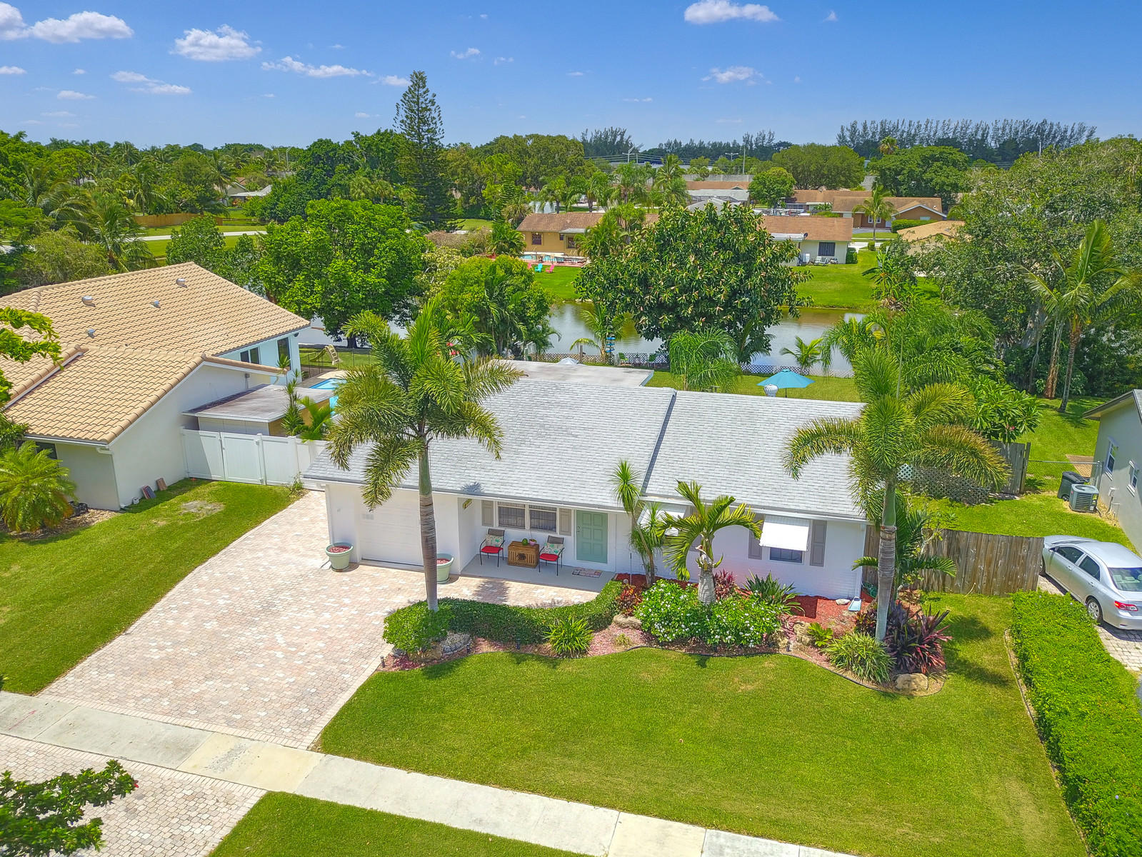 an aerial view of residential houses with outdoor space and trees