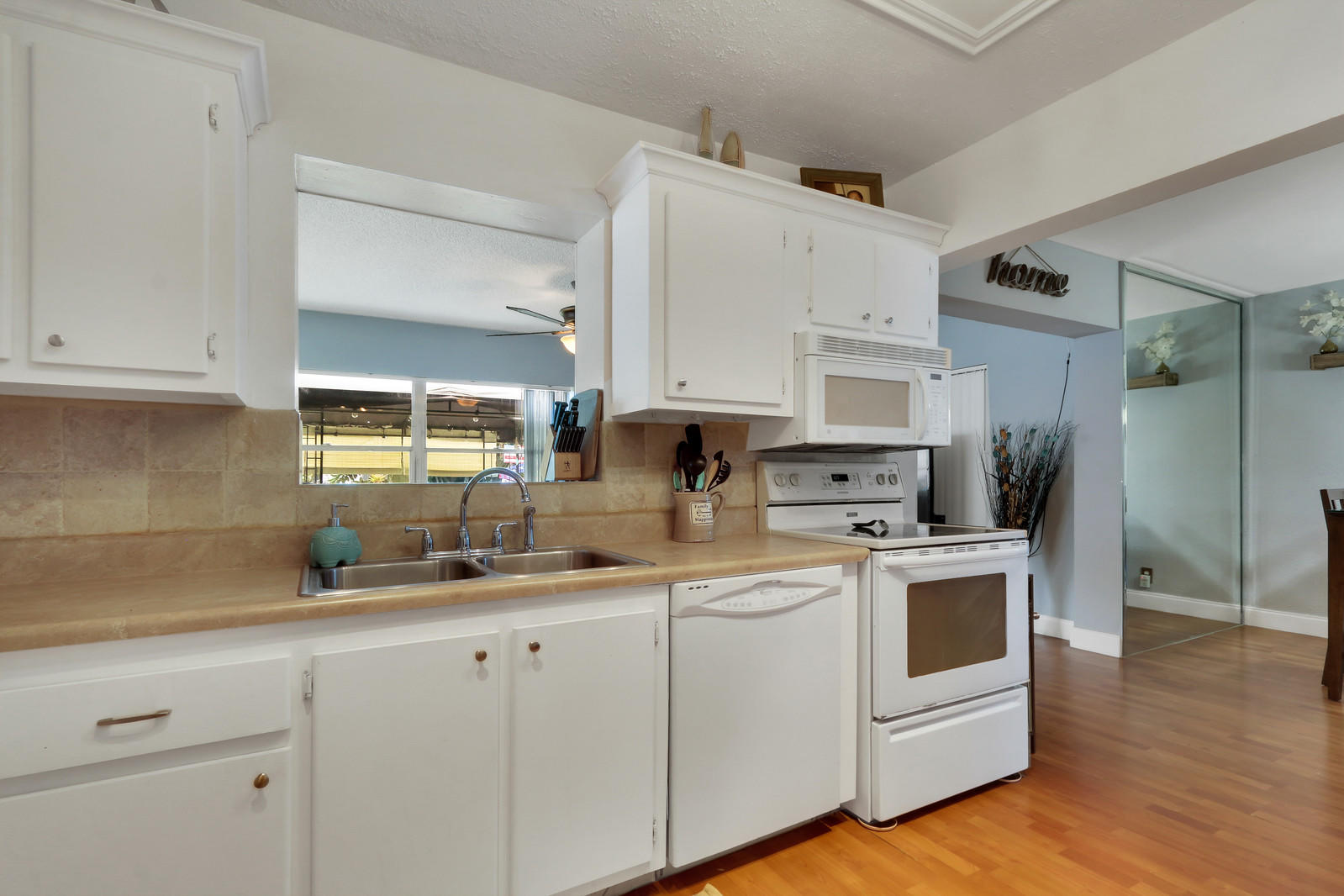 19501 Carolina Circle Boca Raton, FL 33434 - Photo 13 of 19 a kitchen with white cabinets and white appliances