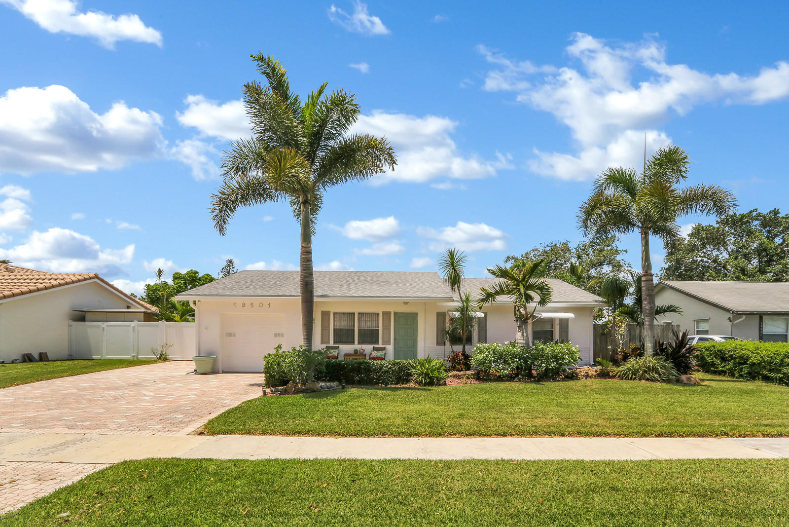 19501 Carolina Circle Boca Raton, FL 33434 - Photo 3 of 19 a front view of a house with a yard and garage