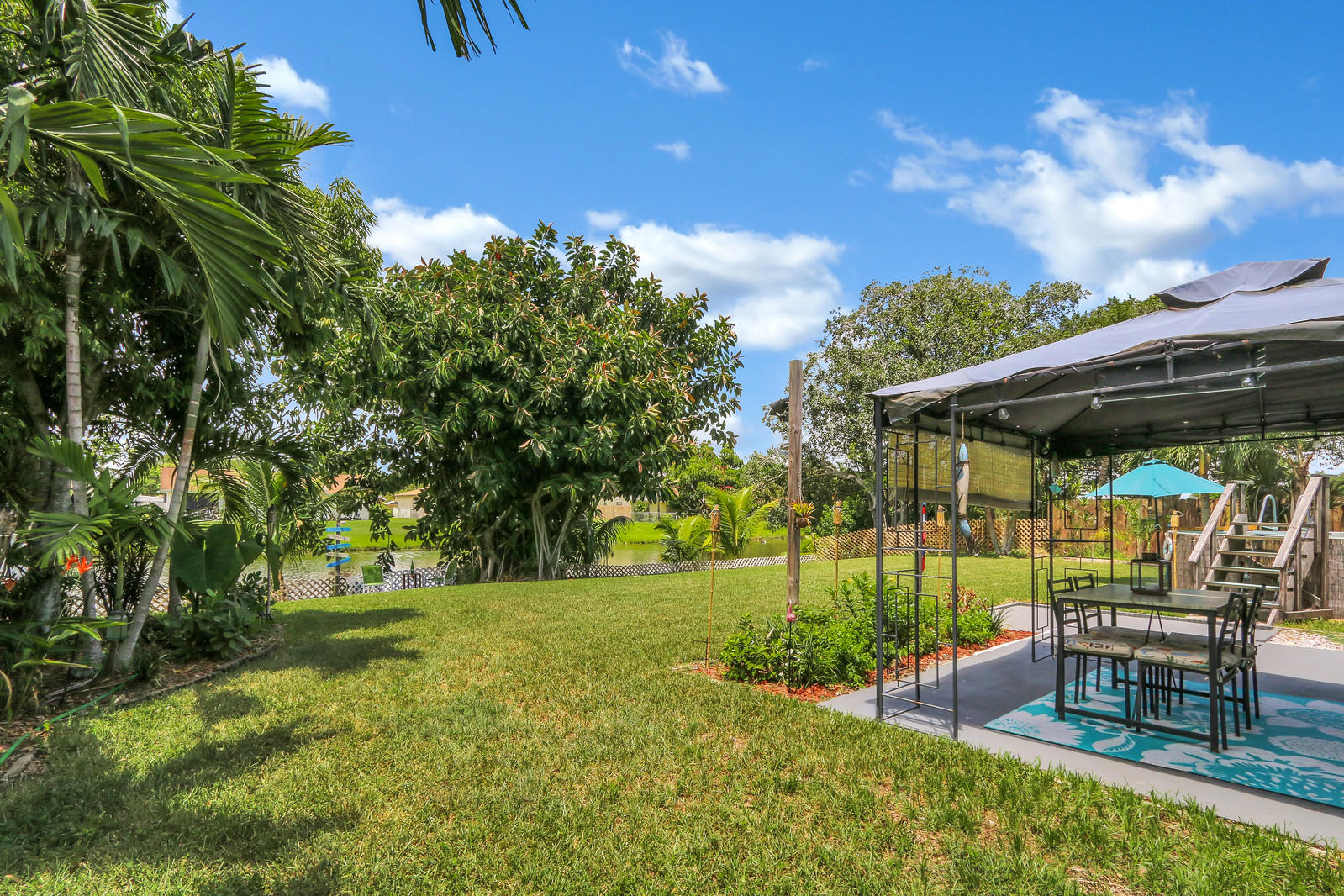 19501 Carolina Circle Boca Raton, FL 33434 - Photo 6 of 19 a view of backyard with table and chairs and potted plants