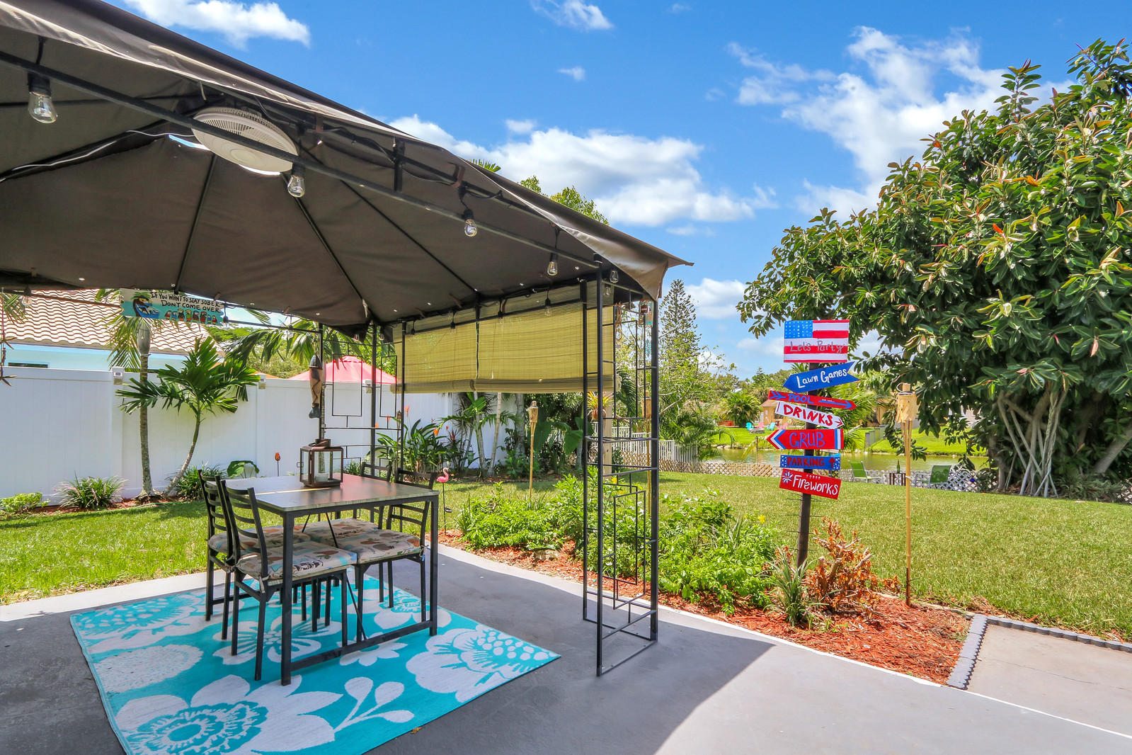 19501 Carolina Circle Boca Raton, FL 33434 - Photo 7 of 19 a view of a table and chairs under an umbrella
