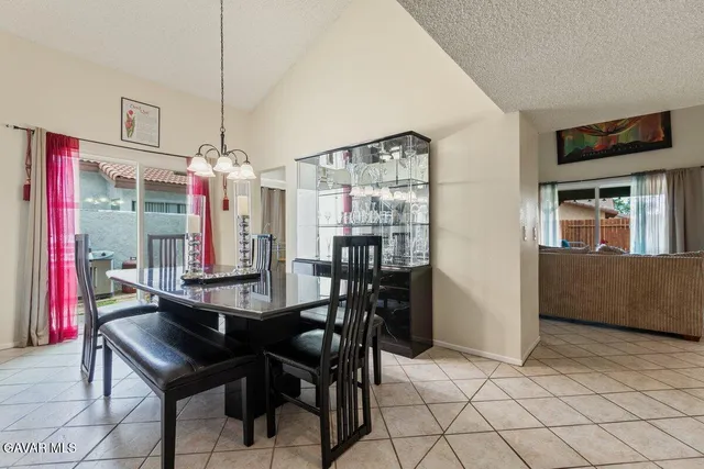 a view of a dining room with furniture and chandelier
