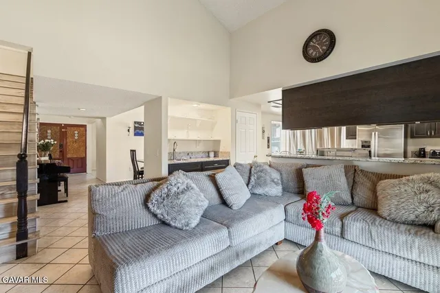 a living room with furniture and kitchen view