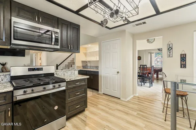 a kitchen with stainless steel appliances granite countertop a stove and cabinets
