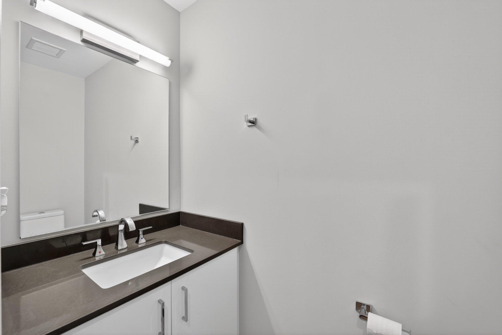 88 V Street Southwest, Unit 213 Washington, DC 20024 - Photo 6 of 26 Sleek modern half bathroom with elegance.
