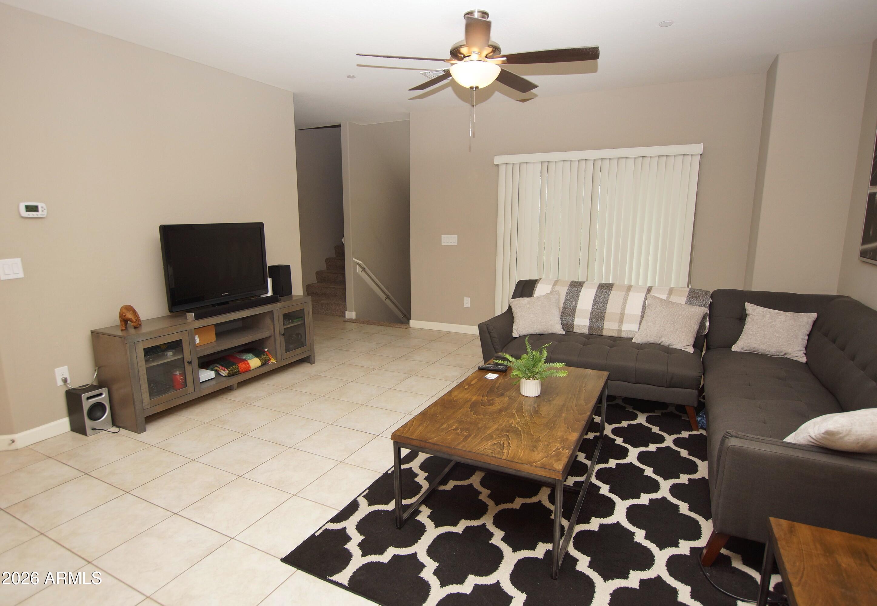 2150 West Alameda Road, Unit 1095 Phoenix, AZ 85085 - Photo 13 of 32 a living room with furniture and a flat screen tv