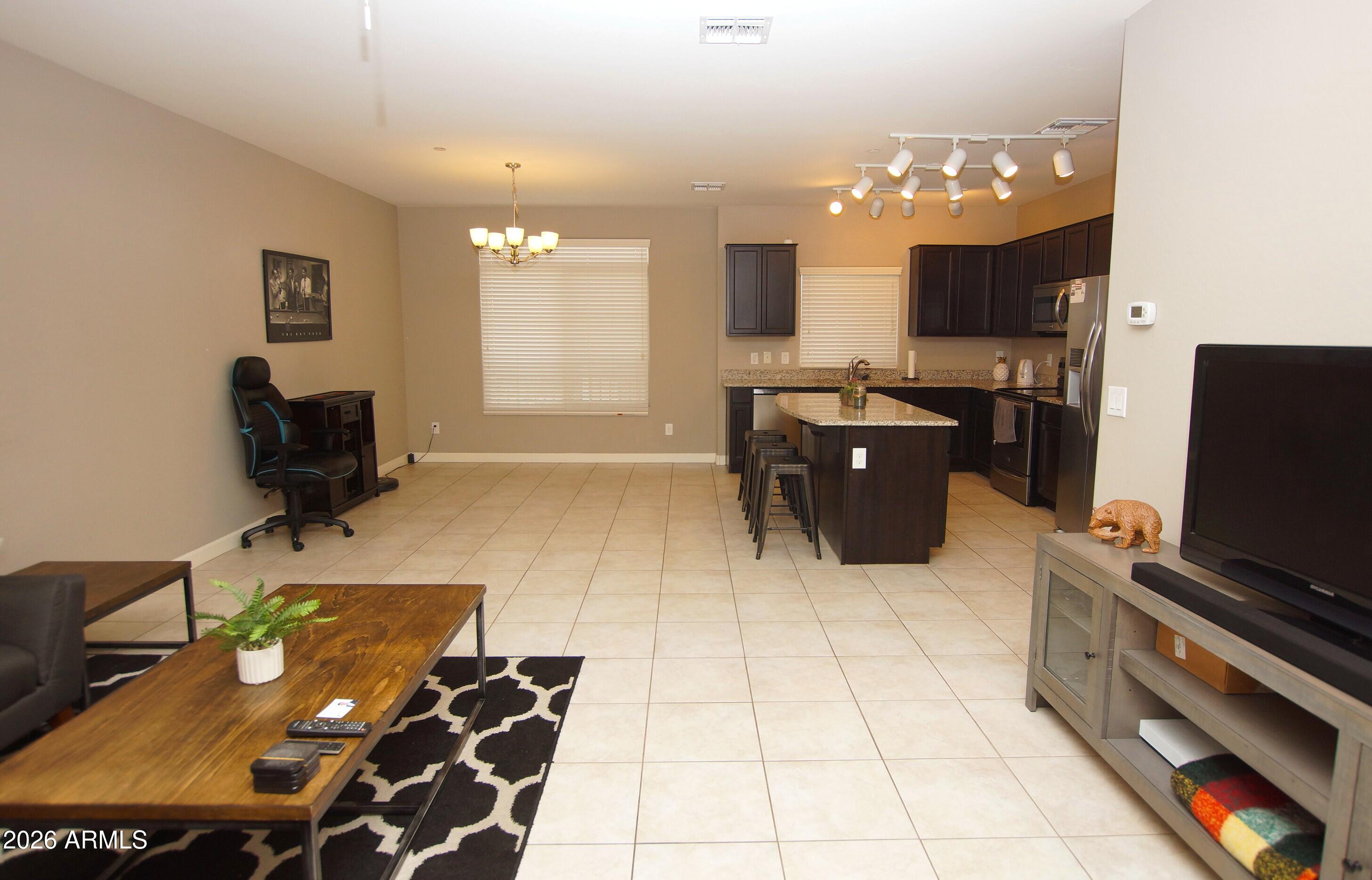 2150 West Alameda Road, Unit 1095 Phoenix, AZ 85085 - Photo 14 of 32 a living room with furniture and flat screen tv