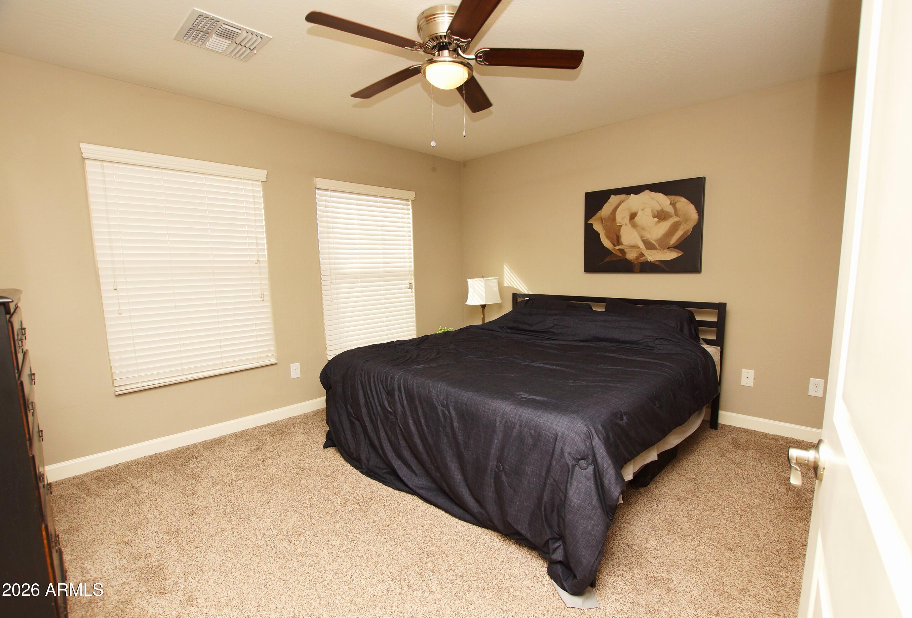 2150 West Alameda Road, Unit 1095 Phoenix, AZ 85085 - Photo 17 of 32 a bedroom with a bed and a window
