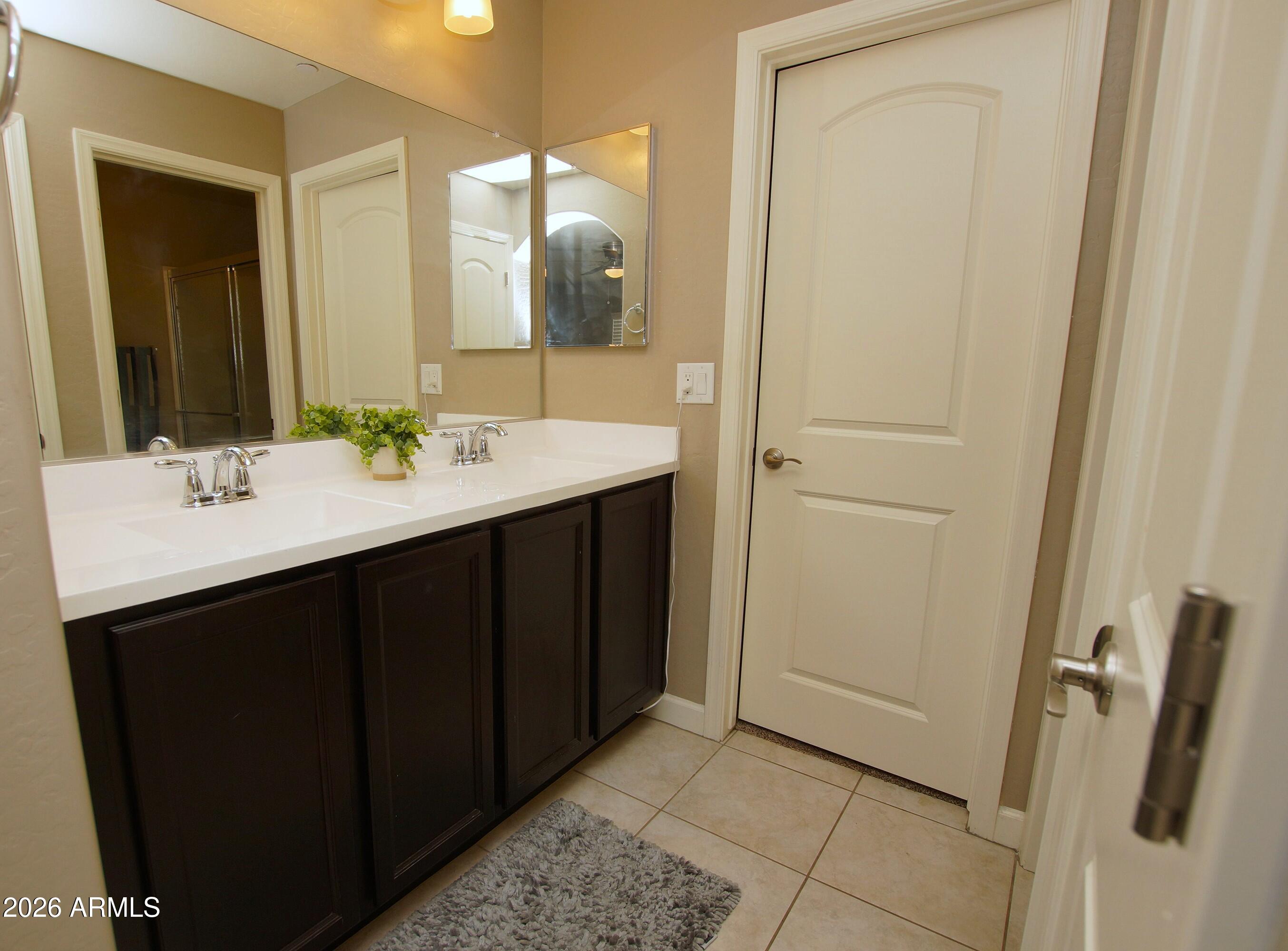 2150 West Alameda Road, Unit 1095 Phoenix, AZ 85085 - Photo 18 of 32 a bathroom with a double vanity sink and a mirror