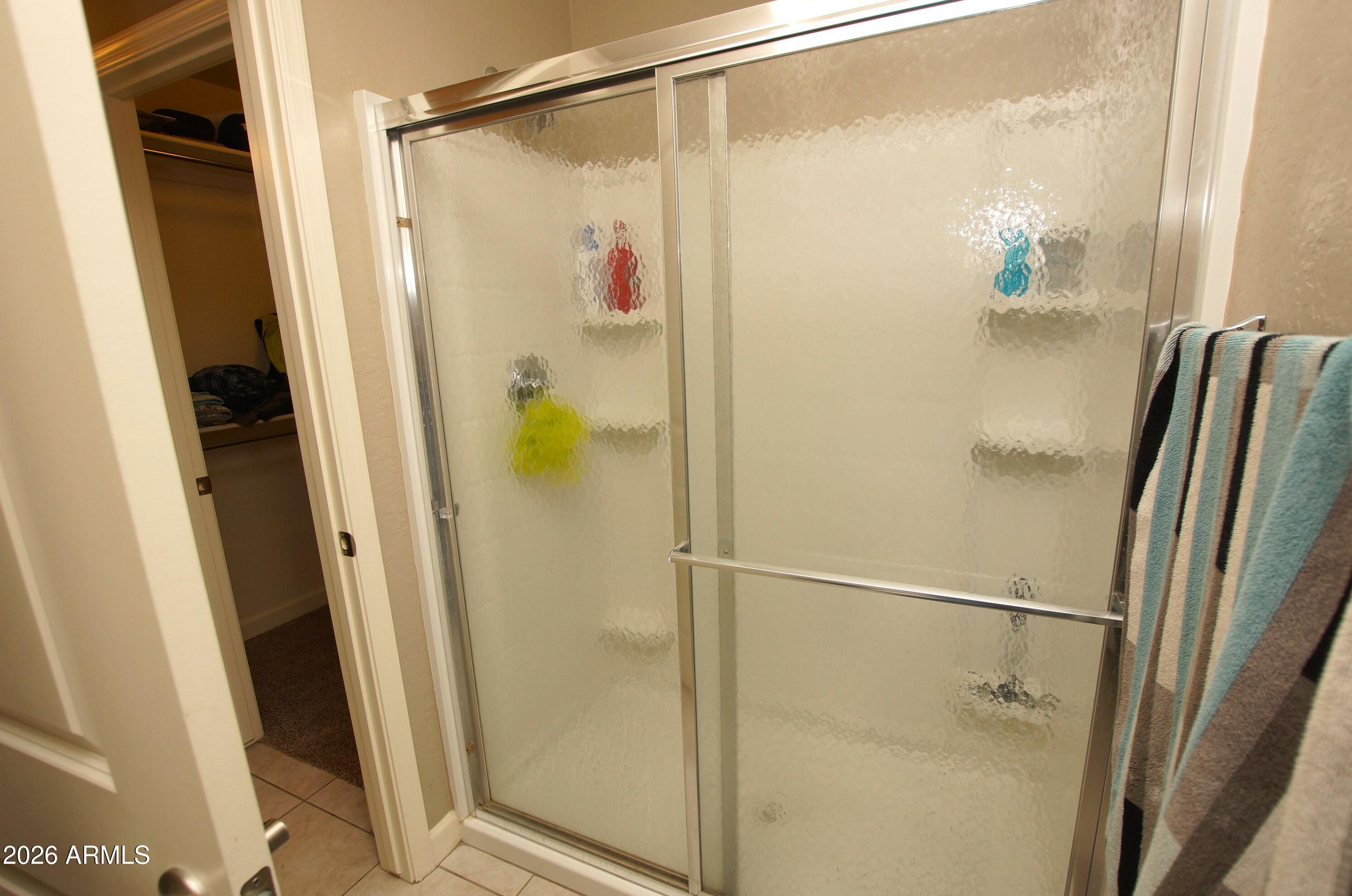 2150 West Alameda Road, Unit 1095 Phoenix, AZ 85085 - Photo 19 of 32 a bathroom with a glass shower door and a sink