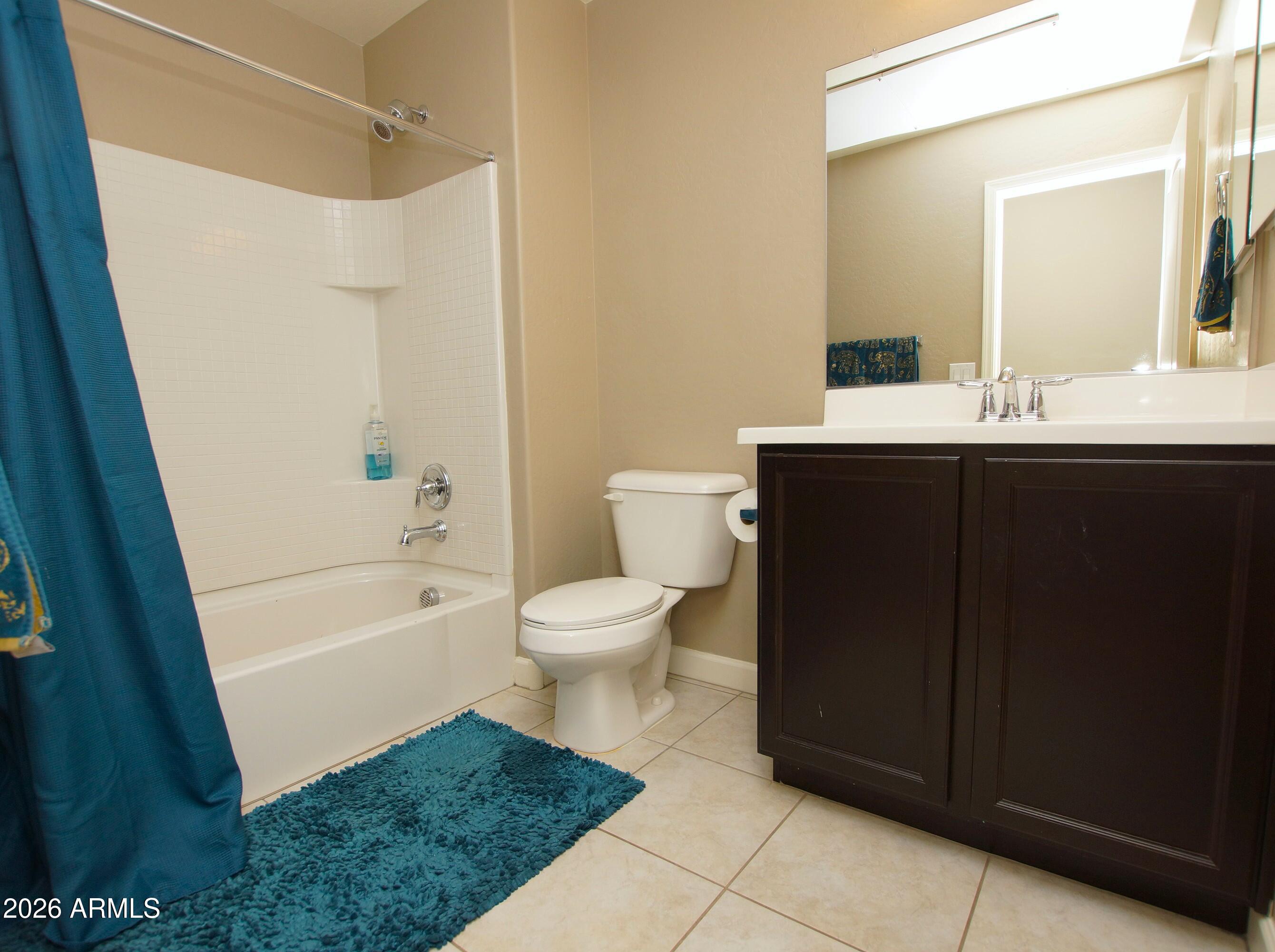 2150 West Alameda Road, Unit 1095 Phoenix, AZ 85085 - Photo 22 of 32 a bathroom with a sink a toilet a mirror a vanity and shower