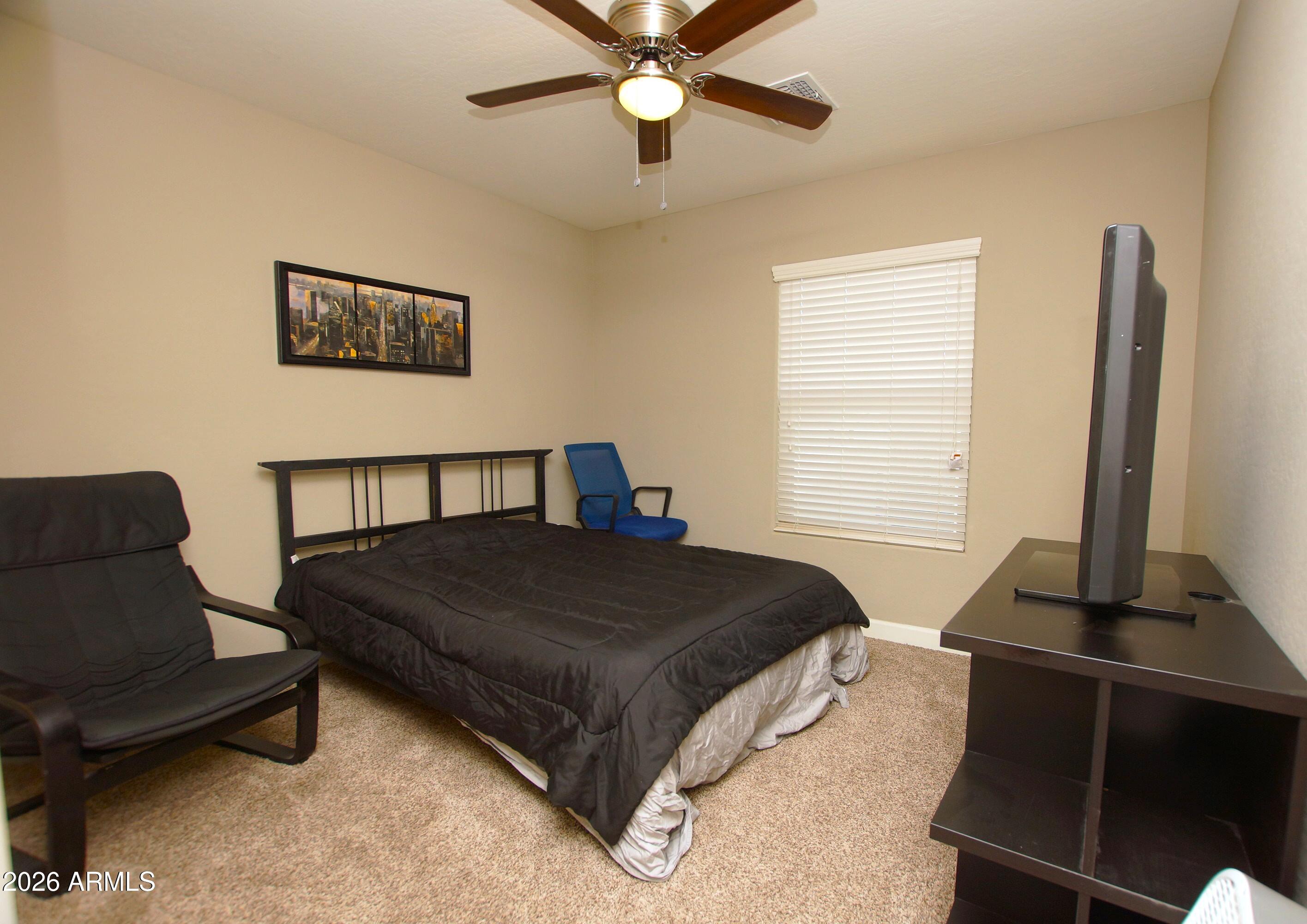 2150 West Alameda Road, Unit 1095 Phoenix, AZ 85085 - Photo 24 of 32 a bedroom with a bed and a couch