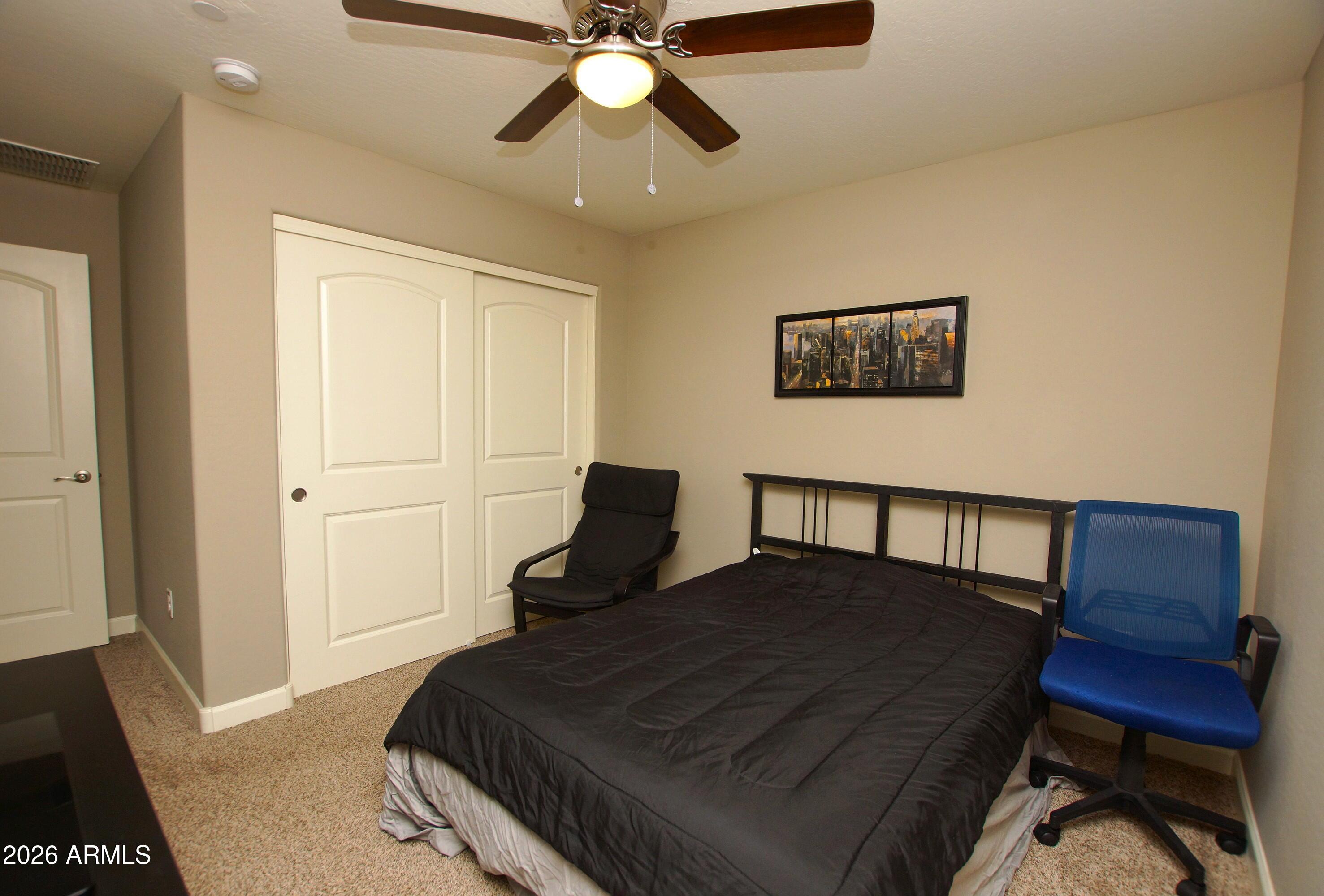 2150 West Alameda Road, Unit 1095 Phoenix, AZ 85085 - Photo 25 of 32 a bedroom with a bed and wooden floor