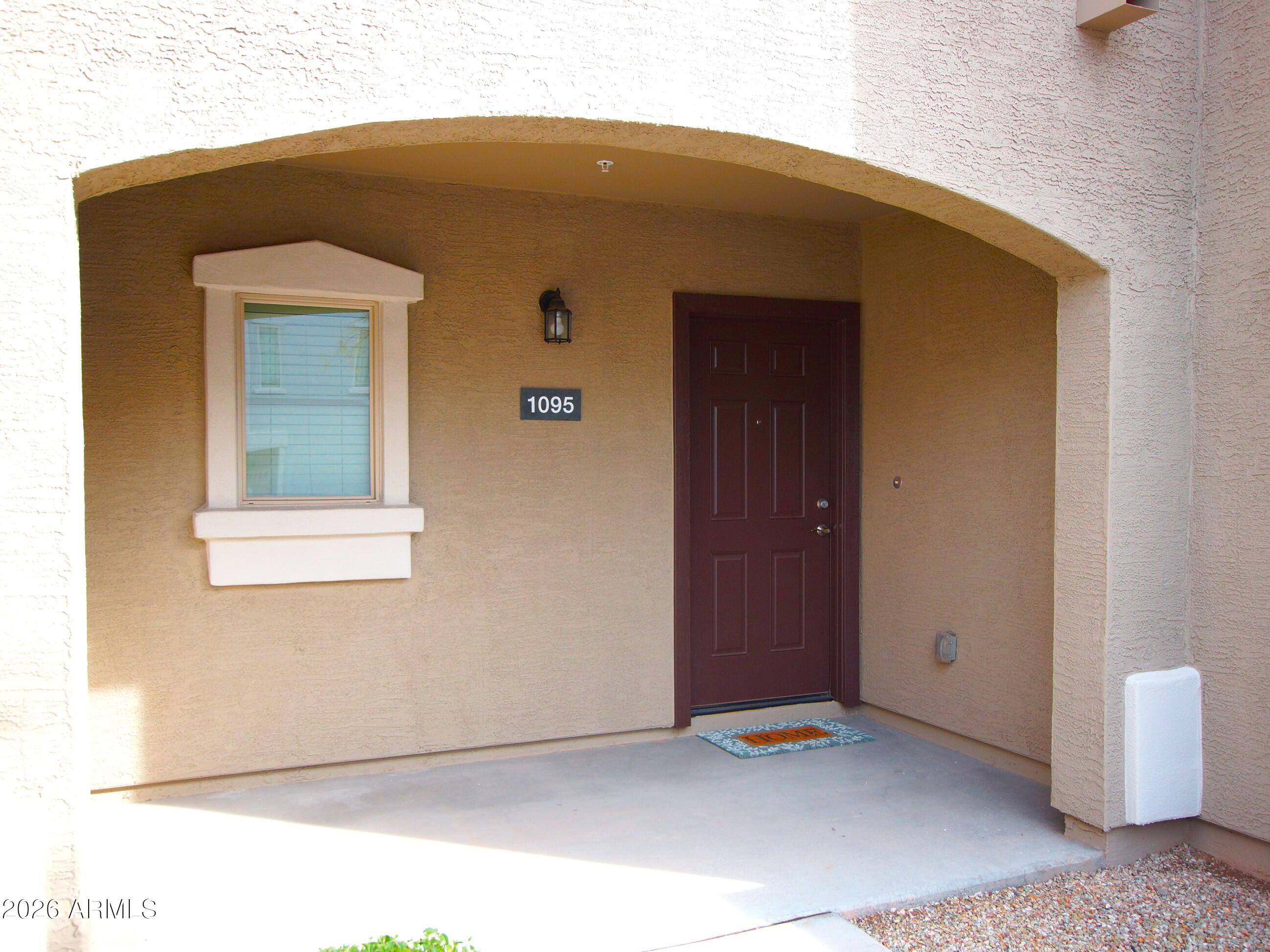 2150 West Alameda Road, Unit 1095 Phoenix, AZ 85085 - Photo 5 of 32 a front view of a house with a garage