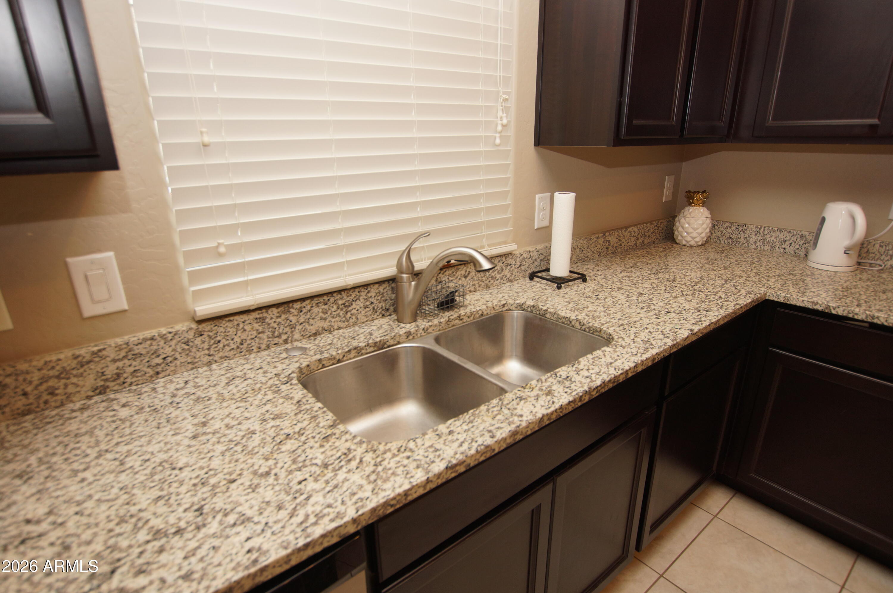 2150 West Alameda Road, Unit 1095 Phoenix, AZ 85085 - Photo 8 of 32 a kitchen with granite countertop a sink and cabinets