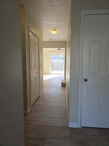 a view of a hallway with wooden floor