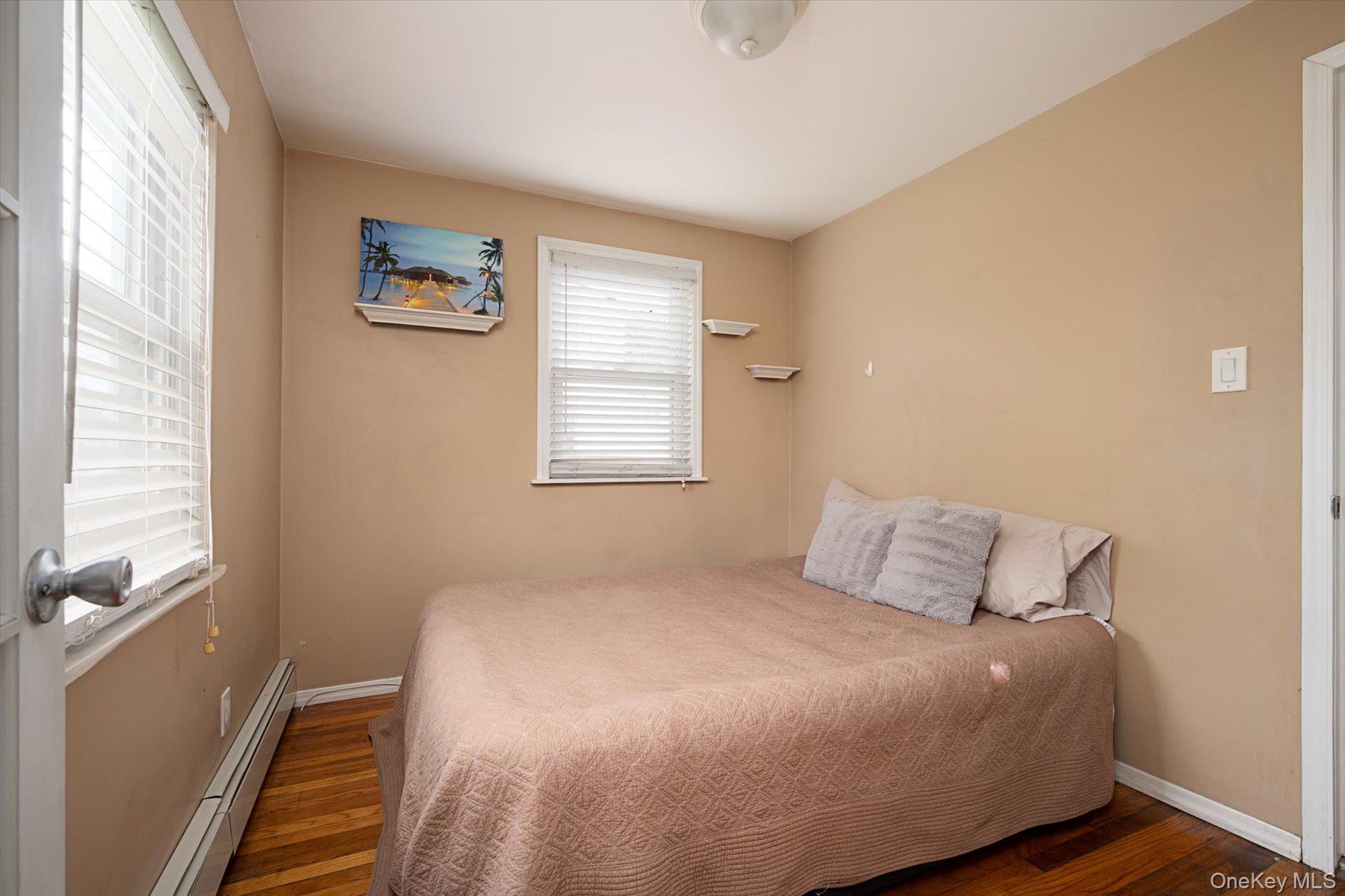 675 Little E Neck Road West Babylon, NY 11704 - Photo 10 of 20 a bedroom with a bed and a window