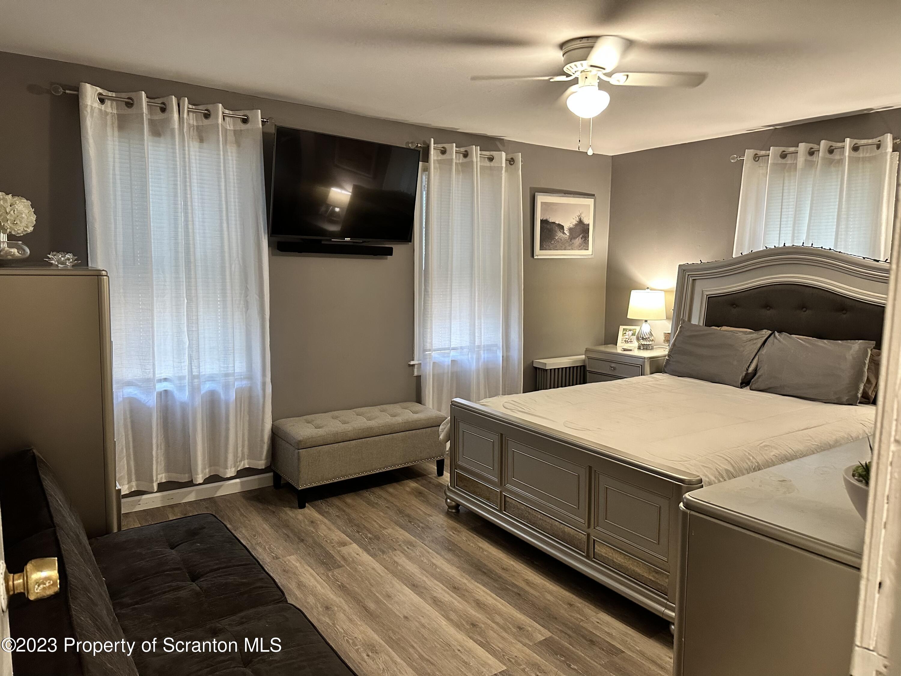 515 Fassold Street Moosic, PA 18507 - Photo 12 of 14 a bedroom with a bed and a chandelier