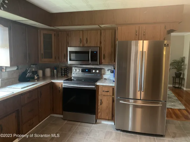 a kitchen with a refrigerator sink and microwave