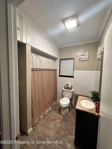 a bathroom with a toilet a sink and a mirror