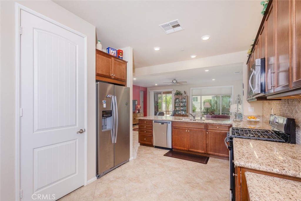 1370 Corte Alamonte Hemet, CA 92545 - Photo 12 of 62 a kitchen with stainless steel appliances granite countertop refrigerator sink and stove