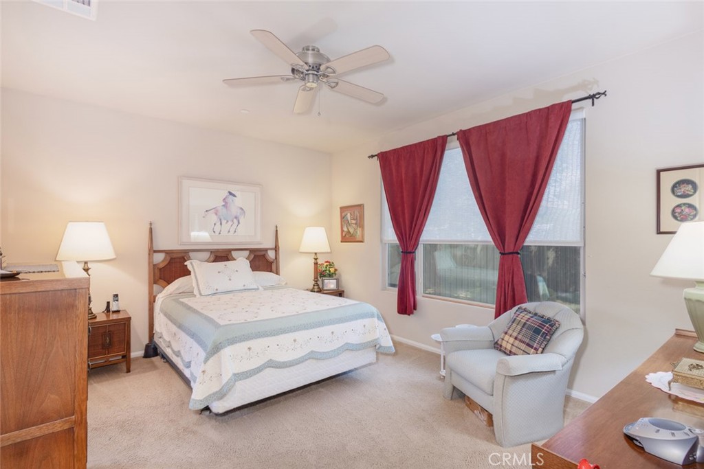 1370 Corte Alamonte Hemet, CA 92545 - Photo 16 of 62 a bedroom with a bed and a chandelier