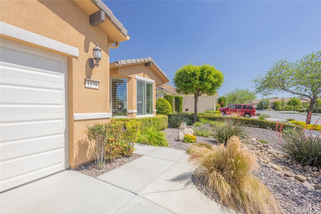 1370 Corte Alamonte Hemet, CA 92545 - Photo 4 of 62 a front view of a house with garden