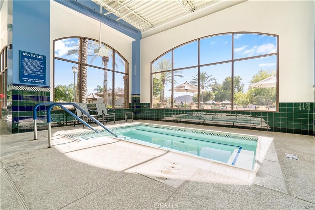 1370 Corte Alamonte Hemet, CA 92545 - Photo 42 of 62 a swimming pool with outdoor seating and a large window